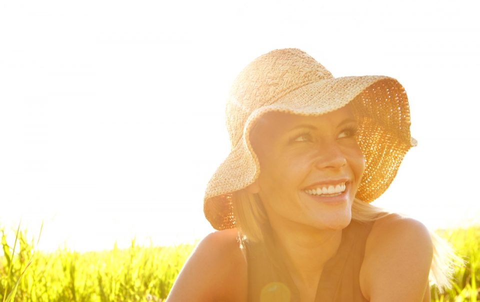 Woman in a sun hat in a field