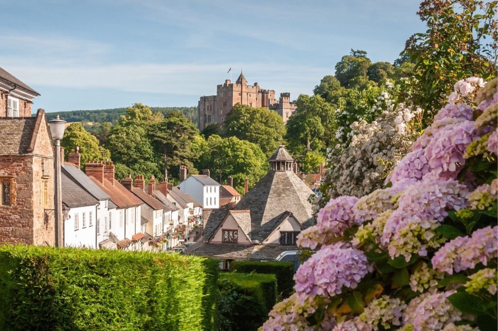 Dunster castle with house in the foreground