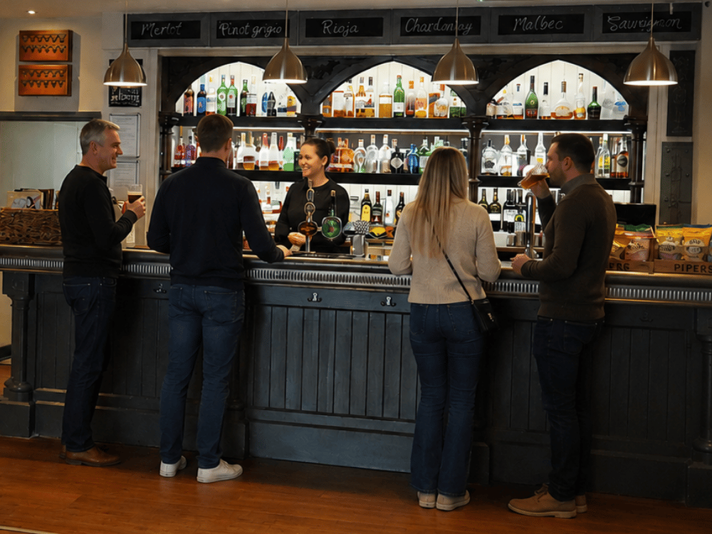 young people drinking at the corner house hotel bar and enjoying the ambience