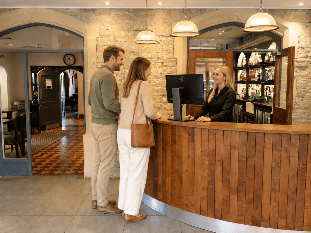 leisure couple checking in at reception to the corner house hotel taunton